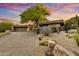 Desert home with mature landscaping and a private driveway leading to the garage at 41590 N 108Th St, Scottsdale, AZ 85262