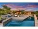 Expansive home exterior overlooking a stunning pool, patio area, and beautifully landscaped backyard at 41590 N 108Th St, Scottsdale, AZ 85262