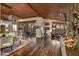 Open living space featuring a stone fireplace, wooden ceilings, and floor-to-ceiling windows at 41590 N 108Th St, Scottsdale, AZ 85262