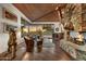 Sun-filled living room featuring a stone fireplace, wooden ceilings, and floor-to-ceiling windows at 41590 N 108Th St, Scottsdale, AZ 85262