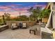 Inviting outdoor patio featuring comfortable seating, desert landscaping, and a breathtaking sunset view at 41590 N 108Th St, Scottsdale, AZ 85262