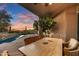 Outdoor seating area offering shade, pool views, and tranquil desert scenery against a colorful sky at 41590 N 108Th St, Scottsdale, AZ 85262