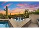 Captivating pool with desert views and a vibrant sunset backdrop, creating a tranquil desert oasis at 41590 N 108Th St, Scottsdale, AZ 85262