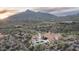 Desert home featuring an expansive pool and patio, set against a dramatic mountain backdrop at 42155 N 97Th Way, Scottsdale, AZ 85262