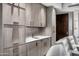 Bar area adjacent to the theater has stylish cabinetry, countertop, and sink at 42155 N 97Th Way, Scottsdale, AZ 85262