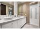 Luxurious bathroom with marble countertops, dual sinks, and a walk-in shower at 42155 N 97Th Way, Scottsdale, AZ 85262