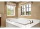 Elegant bathtub with windows offering views of the surrounding desert landscape at 42155 N 97Th Way, Scottsdale, AZ 85262
