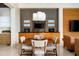 Cozy dining area with a round table, stylish chairs, and custom cabinets in an open floor plan at 42155 N 97Th Way, Scottsdale, AZ 85262