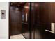 Modern wooden elevator features a metal door and user interface at 42155 N 97Th Way, Scottsdale, AZ 85262