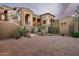 Striking view of an elegant home featuring desert landscaping and a spacious driveway made of pavers at 42155 N 97Th Way, Scottsdale, AZ 85262