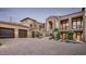 Elegant two-story home featuring a spacious driveway, manicured landscaping, and a three-car garage at 42155 N 97Th Way, Scottsdale, AZ 85262
