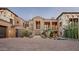 Stately desert home with stone accents, a paver driveway, and lush xeriscaping for elegant curb appeal at 42155 N 97Th Way, Scottsdale, AZ 85262
