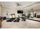 Bright home gym featuring a treadmill, elliptical, full mirror wall, and mounted television at 42155 N 97Th Way, Scottsdale, AZ 85262