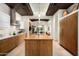 Gourmet kitchen featuring a large island with wood cabinets, modern appliances, and an open floor plan at 42155 N 97Th Way, Scottsdale, AZ 85262