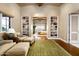 Inviting living room with custom bookshelves and hardwood floors leading to a bedroom view at 42155 N 97Th Way, Scottsdale, AZ 85262