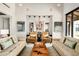 Comfortable living room featuring stylish furniture, neutral tones, and a beautiful chandelier in the distance at 42155 N 97Th Way, Scottsdale, AZ 85262