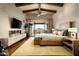 Charming main bedroom with fireplace, wood beams, and balcony with a mountain view at 42155 N 97Th Way, Scottsdale, AZ 85262