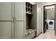 Mudroom includes bench with seating, storage cabinets, and access to laundry area at 42155 N 97Th Way, Scottsdale, AZ 85262