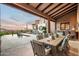 Inviting covered patio featuring an outdoor dining area and luxurious pool at 42155 N 97Th Way, Scottsdale, AZ 85262