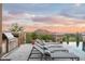 Luxury outdoor living space with a built-in grill, lounge chairs, an infinity pool, and mountain views at 42155 N 97Th Way, Scottsdale, AZ 85262