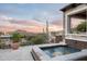 Relaxing spa area with a hot tub, stone accents, desert views, and lush landscaping at 42155 N 97Th Way, Scottsdale, AZ 85262