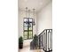 Staircase with decorative hanging lights, desert view, and black metal banister at 42155 N 97Th Way, Scottsdale, AZ 85262