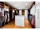 Spacious walk-in closet with custom shelving, abundant storage, and hardwood floors at 42155 N 97Th Way, Scottsdale, AZ 85262