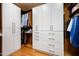 Custom walk-in closet with built-in storage and organizers for clothes and accessories at 42155 N 97Th Way, Scottsdale, AZ 85262
