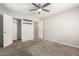 Bedroom with neutral walls, carpeted floors, ceiling fan, closet and open door at 4303 N 18Th St, Phoenix, AZ 85016