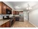Kitchen with stainless appliances, dark cabinets, and durable tile flooring for easy maintenance at 4303 N 18Th St, Phoenix, AZ 85016