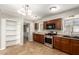 Well-equipped kitchen featuring stainless steel appliances, tiled floors and dark cabinets at 4303 N 18Th St, Phoenix, AZ 85016