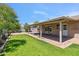A spacious backyard features lush green grass and a covered patio, perfect for outdoor living at 5319 E Gelding Dr, Scottsdale, AZ 85254