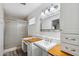 Bright bathroom featuring walk-in shower, vanity sink, and built-in storage at 5319 E Gelding Dr, Scottsdale, AZ 85254