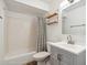 Bright bathroom featuring a shower-tub combination, floating shelves, and a modern vanity at 5319 E Gelding Dr, Scottsdale, AZ 85254
