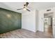 Bedroom featuring wood-look floors, statement wall, and ample closet space at 5319 E Gelding Dr, Scottsdale, AZ 85254