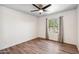Bedroom featuring wood-look floors, a ceiling fan, and a window overlooking the neighborhood at 5319 E Gelding Dr, Scottsdale, AZ 85254