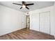 Bedroom featuring wood-look floors, a ceiling fan and a closet with sliding doors at 5319 E Gelding Dr, Scottsdale, AZ 85254