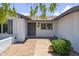 Inviting front entrance with brick pathway, decorative plants, and a charming, sheltered entryway at 5319 E Gelding Dr, Scottsdale, AZ 85254