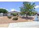Charming single-story home featuring lush landscaping, mature trees, and a well-maintained gravel yard at 5319 E Gelding Dr, Scottsdale, AZ 85254