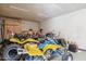 Spacious garage filled with off-road vehicles and gear, offering ample storage and workspace at 5319 E Gelding Dr, Scottsdale, AZ 85254