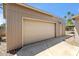 Two-car garage featuring beige paint and a large door, providing ample parking and storage space at 5319 E Gelding Dr, Scottsdale, AZ 85254