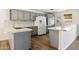 Modern kitchen with gray cabinetry, white countertops, and stainless steel appliances at 5319 E Gelding Dr, Scottsdale, AZ 85254