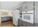 Open-concept kitchen features gray cabinets, stainless steel appliances, and a bright, airy atmosphere at 5319 E Gelding Dr, Scottsdale, AZ 85254