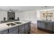 Modern kitchen boasts gray cabinets, white countertops, and a sleek island with an integrated cooktop at 5319 E Gelding Dr, Scottsdale, AZ 85254