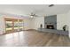Spacious living room with a cozy brick fireplace and sliding glass doors leading to the outdoor space at 5319 E Gelding Dr, Scottsdale, AZ 85254