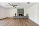 Open living area features a brick fireplace, a ceiling fan, and neutral tones for a serene ambiance at 5319 E Gelding Dr, Scottsdale, AZ 85254