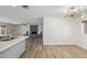 Open living space features gray brick fireplace, hardwood floors, and modern light fixture at 5319 E Gelding Dr, Scottsdale, AZ 85254