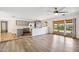 Spacious open-concept living room and kitchen featuring wood floors, updated cabinets, and bright natural light at 5319 E Gelding Dr, Scottsdale, AZ 85254