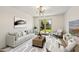Bright living room features modern chandelier, neutral colors, and access to outdoor space at 5319 E Gelding Dr, Scottsdale, AZ 85254