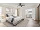 Bright main bedroom with ceiling fan, neutral décor, and en-suite bathroom at 5319 E Gelding Dr, Scottsdale, AZ 85254